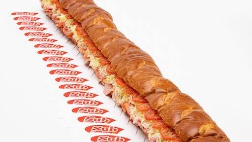 A giant Sub Station II sub, cut and lined up next to a row of Sub Station II napkins