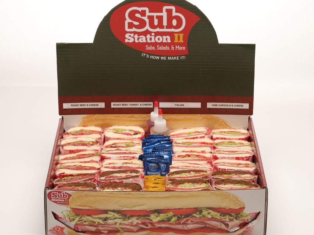 A Sub Station II catering box tray full of wrapped subs